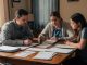 Une famille composée d’un homme, d’une femme et de leur fille adolescente examine calmement des documents vierges liés à la gestion du budget familial autour d’une table, dans une ambiance sobre éclairée par la lumière naturelle.